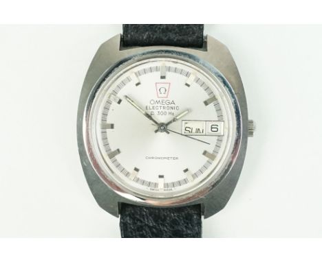 Omega electronic f 300 hz chronometer wrist watch having a round face with baton markers to the chapter ring, with day and da