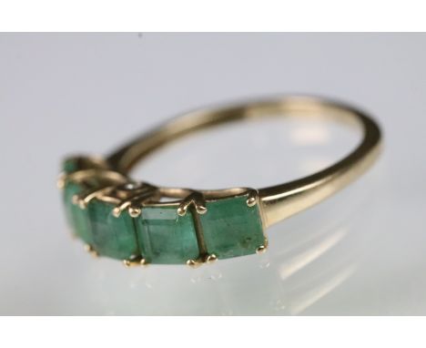 9ct gold and emerald five stone ring being set with square emerald cut emeralds in prong settings. Hallmarked Sheffield. Size