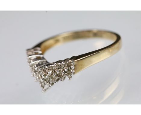 9ct gold and diamond wishbone ring being set with two rows of round cut diamonds in prong settings on a plain band. Hallmarke