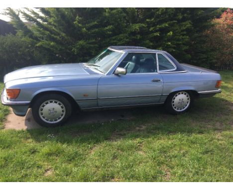 A 1986 Mercedes-Benz 500SL, registration number D978 NOH, light metallic blue. The Mercedes-Benz R107 series of roadsters and