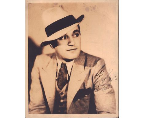 Portrait of an elegantly dressed man looking up in a quarter turn pose.Hand signed legible writing 'To Dotty, with best wishe