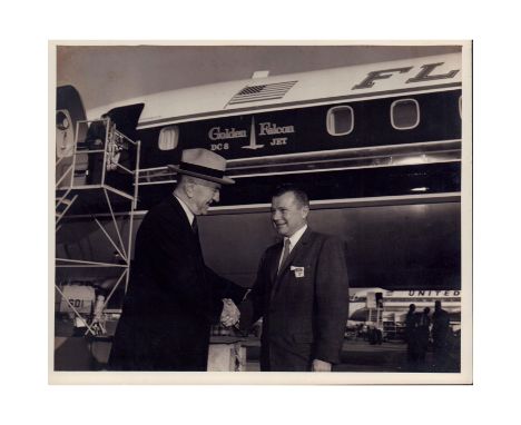 Rare photo of Eddie Rickenbacker shaking hands with another gentleman in front the 'Golden Falcon' DC-8 Jet.'C8-2669-24, 1-7-