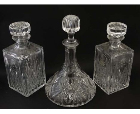 A pair of cut glass/ crystal decanters of squared form together with a ships decanter. The tallest 11" high (2+1) CONDITION: 