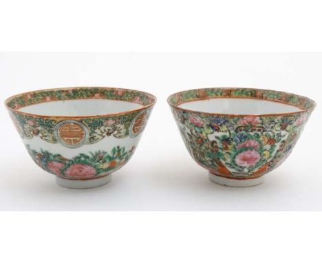 A pair of Canton enamel painted bowls, one decorated with shou characters and peaches, the other with butterflies and flowers