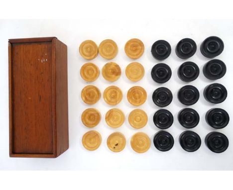 A set of wooden checkers / draughts set, finished in black and natural , in a wooden box. Each checker 1 1/4'' diameter.  CON