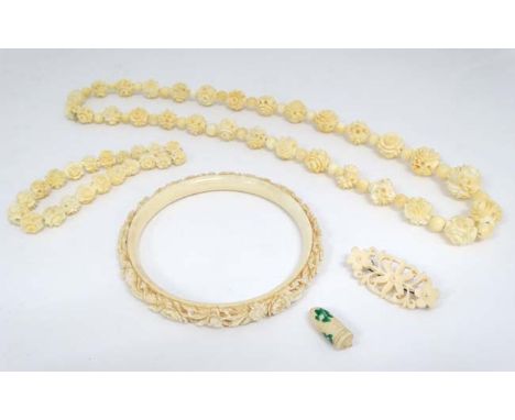 A 19thC Cantonese carved ivory bangle together with a bead necklace  (2) CONDITION: Please Note -  we do not make reference t