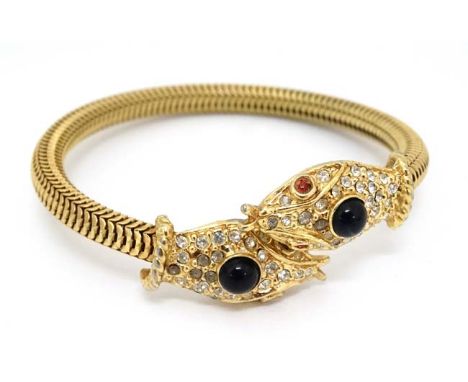A gilt metal bracelet of bangle form the ends terminating in snake head decoration  CONDITION: Please Note -  we do not make 