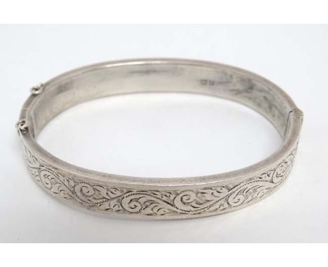 A silver bracelet of bangle form hallmarked Birmingham 1956 maker Joseph Gloster Ltd.  CONDITION: Please Note -  we do not ma