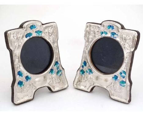 A pair of 21stC photograph frames with silver and enamel decorative surrounds in the Art Nouveau style. Approx 4 1/2" high  C