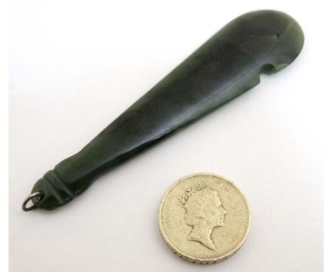 An Oriental green jade pendant in the form of a club 3 1/2" long  CONDITION: Please Note -  we do not make reference to the c