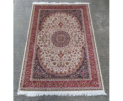 Carpet / Rug :A beige ground Keshan style carpet measuring 63 1/2 x 96 1/2" CONDITION: Please Note -  we do not make referenc