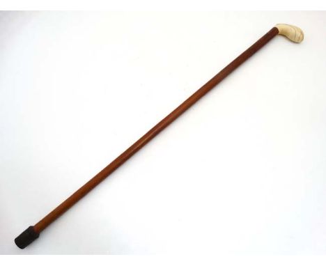 Walking Stick : A 19 thC ivory palm swell handle on a malacca shaft ,34 1/2" long    CONDITION: Please Note -  we do not make