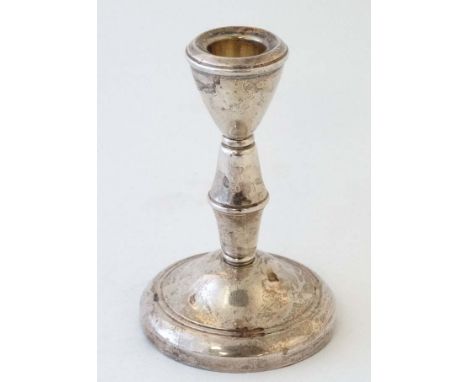 A silver candlestick hallmarked Birmingham 1961 maker Sanders & Mackenzie 4 3/4" high  CONDITION: Please Note -  we do not ma