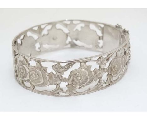 A Continental .800 silver bangle with open work floral decoration. CONDITION: Please Note -  we do not make reference to the 