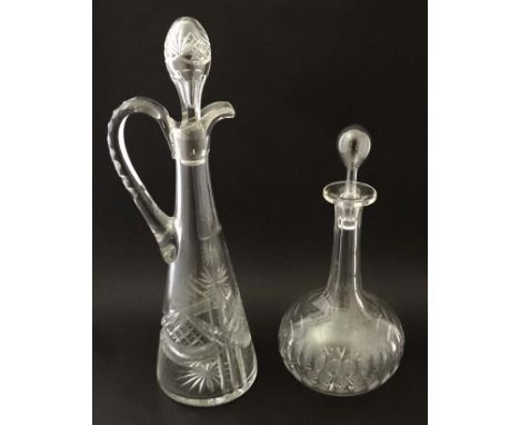 A tall cut glass claret jug together with an onion shaped glass decanter with facet cut decoration. The tallest 16 3/4" . (2)
