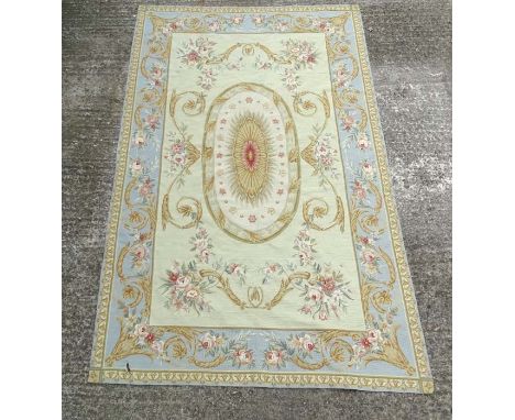 Carpet / Rug: an Aubusson woollen carpet in light sage ground with light blue border, and various gold and browns having a fl