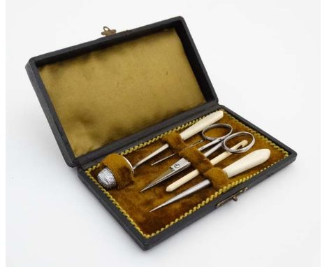 A c.1900 necessaire box opening to reveal a quantity of sewing tools. 5 3/8" long x 3 1/8" deep  CONDITION: Please Note -  we