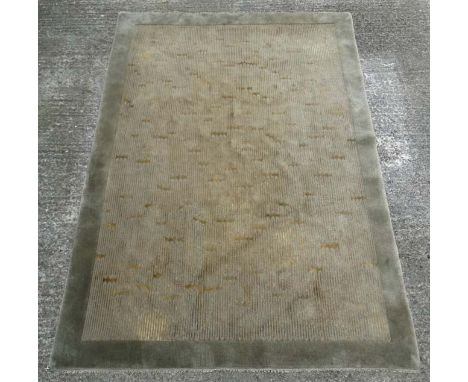 Carpet / Rug : a mid- late 20thc Nepalese rug made in wool with sage green, yellow/gold colours in a contemporary design styl