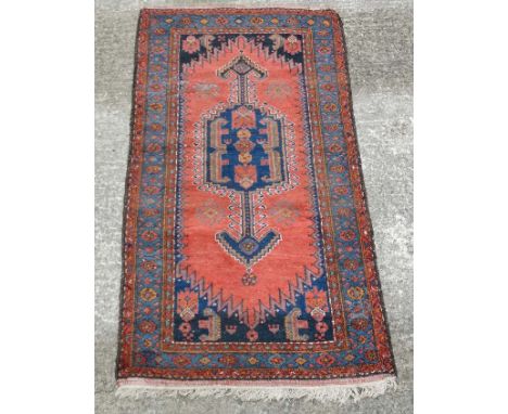 Carpet / Rug : A woollen rug with blue and red/pink ground with geometric arrow like motifs 81'' x 43"  CONDITION: Please Not