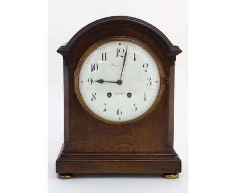 Finnegans Ltd Manchester : an 8 day bracket Clock striking on a coiled gong in a Mahogany stained oak case , with convex 7 1/