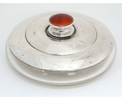 A glass dressing table pot with radiating star cut decoration to base and silver top with red guilloché enamel decoration to 