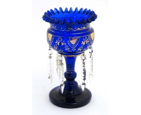 A blue glass pedestal table lustre with gilt and enamel deocration, frilled rim  and lustre drops. 9 1/2" high  CONDITION: Pl