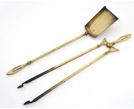 Two early 20thC brass fire tools comprising tong and shovel with ornate handle. each approx 26" long  CONDITION: Please Note 
