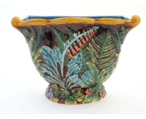 A large Minton Majolica wall planter / jardineire , decorated with fox gloves, decorated in shades of green and orange on a b