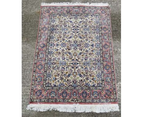Carpet / Rug: a Signed Pakistan made deepish pile (silk like ) woollen hand made rug , with salmon pink border and light buff