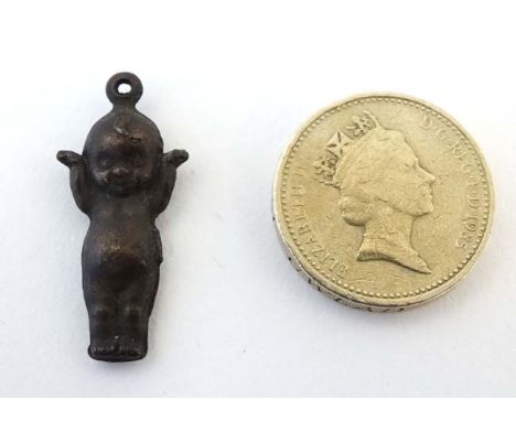 A pendant / charm formed as a kewpie doll 1 ¼” long  CONDITION: Please Note -  we do not make reference to the condition of l