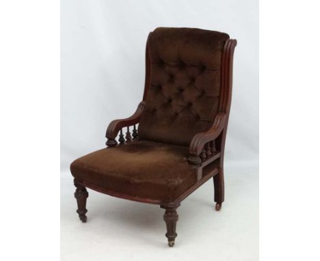 A late 19thC mahogany elbow chair with button back upholstery and fluted and turned front legs. 37" high  CONDITION: Please N
