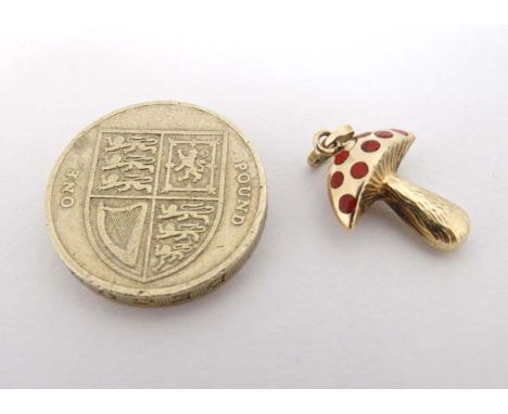 A 14ct (585) gold pendant / charm formed as a toadstool with red enamel decoration. Approx ¾" high  CONDITION: Please Note - 