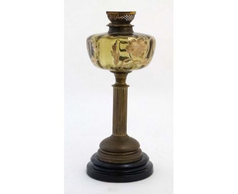 An unusual oil lamp with reeded column, circular base and gilt with tube lined enamel amber coloured resevoir.16" high CONDIT