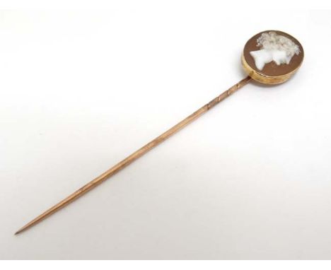 A gilt metal stick pin surmounted by a classical cameo.  CONDITION: Please Note -  we do not make reference to the condition 