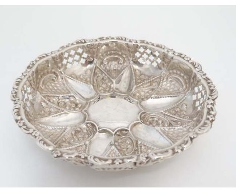 A silver bon bon dish of circular form with embossed and pierced decoration on 3 ball feet hallmarked Birmingham 1901 maker M