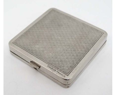A mid 20thC silver plate ladies powder compact by Coty France with engine turned decoration and mirror to lid. Approx 1 3/4" 
