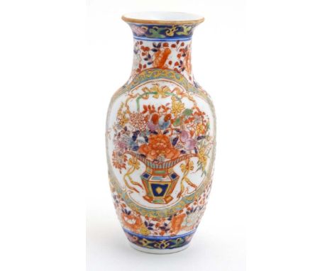 An oriental baluster-shaped vase, enamel-painted with floral bouquets. 8 1/4" high CONDITION: Please Note -  we do not make r