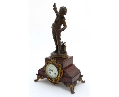 French Clock : a red marble cased mantle clock  with ormolou mounts surmounted by a spelter figure entitled " Sortier d'Ecole