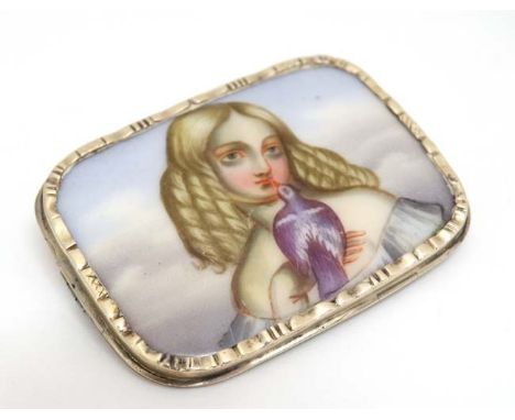 A yellow metal brooch set with hand painted ceramic panel depicting a young girl holding a dove. Approx 1 ¾” wide  CONDITION: