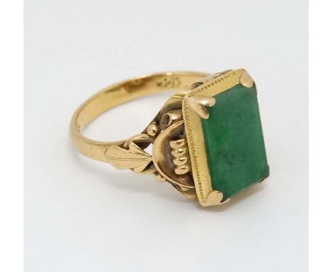 A Chinese 22ct gold ring set with jade like hardstone stone to top CONDITION: Please Note -  we do not make reference to the 