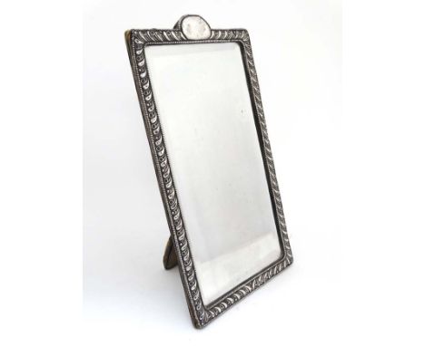 A strut/ easel backed mirror with silver surround and central beveled mirror. Hallmarked Chester 1901 maker James Deakin & So