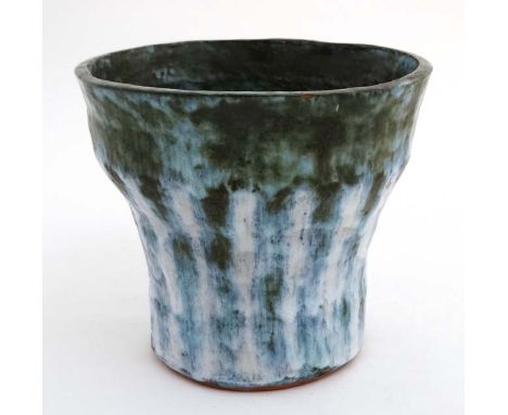 A Studio Pottery Planter / Jardiniere decorated in shades of blue and green on a white ground bears impressed N S and weather