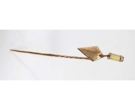 A 9ct gold stick pin surmounted by a 9ct gold miniature trowel.  The whole 2 ½" long  CONDITION: Please Note -  we do not mak