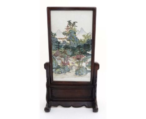A Chinese famille rose ceramic panel , in wooden frame on wooden stand, the panel decorated in polychrome with figures and pa