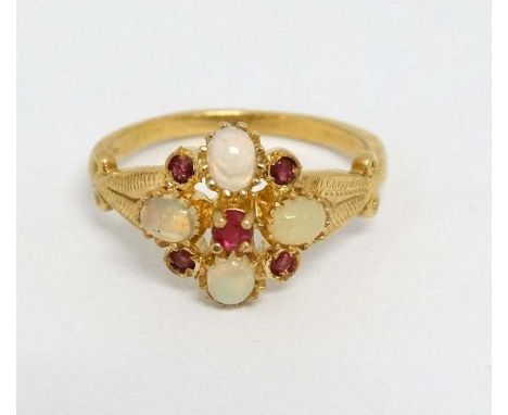 A silver gilt ring set with opal like cabochon and red stones. Marked 'Sil'  CONDITION: Please Note -  we do not make referen