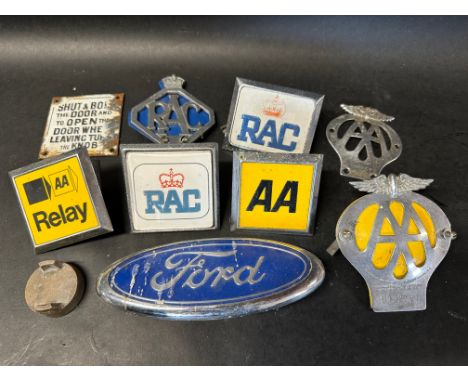 A small enamel vending machine sign and a selection of car badges etc.
