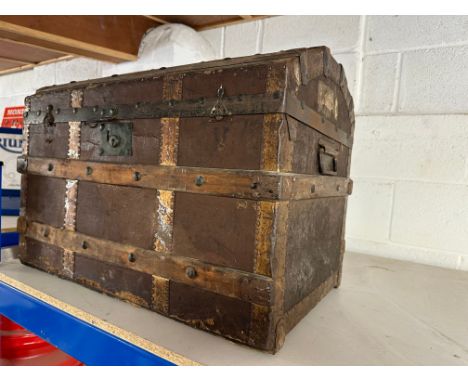 A wooden bound dome topped trunk.