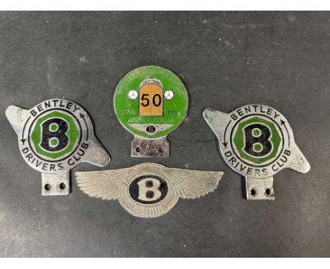 A Bentley Drivers Club Golden Jubilee enamel badge and three other Bentley badges.