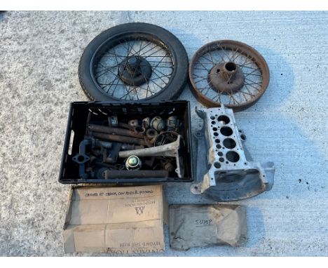 A quantity of Austin 7 parts including crankcase, 18" wire wheel, engine parts etc.