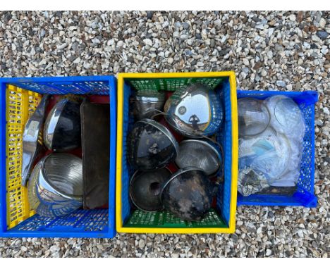 Two crates of headlamps plus a tray of headlamp glass.